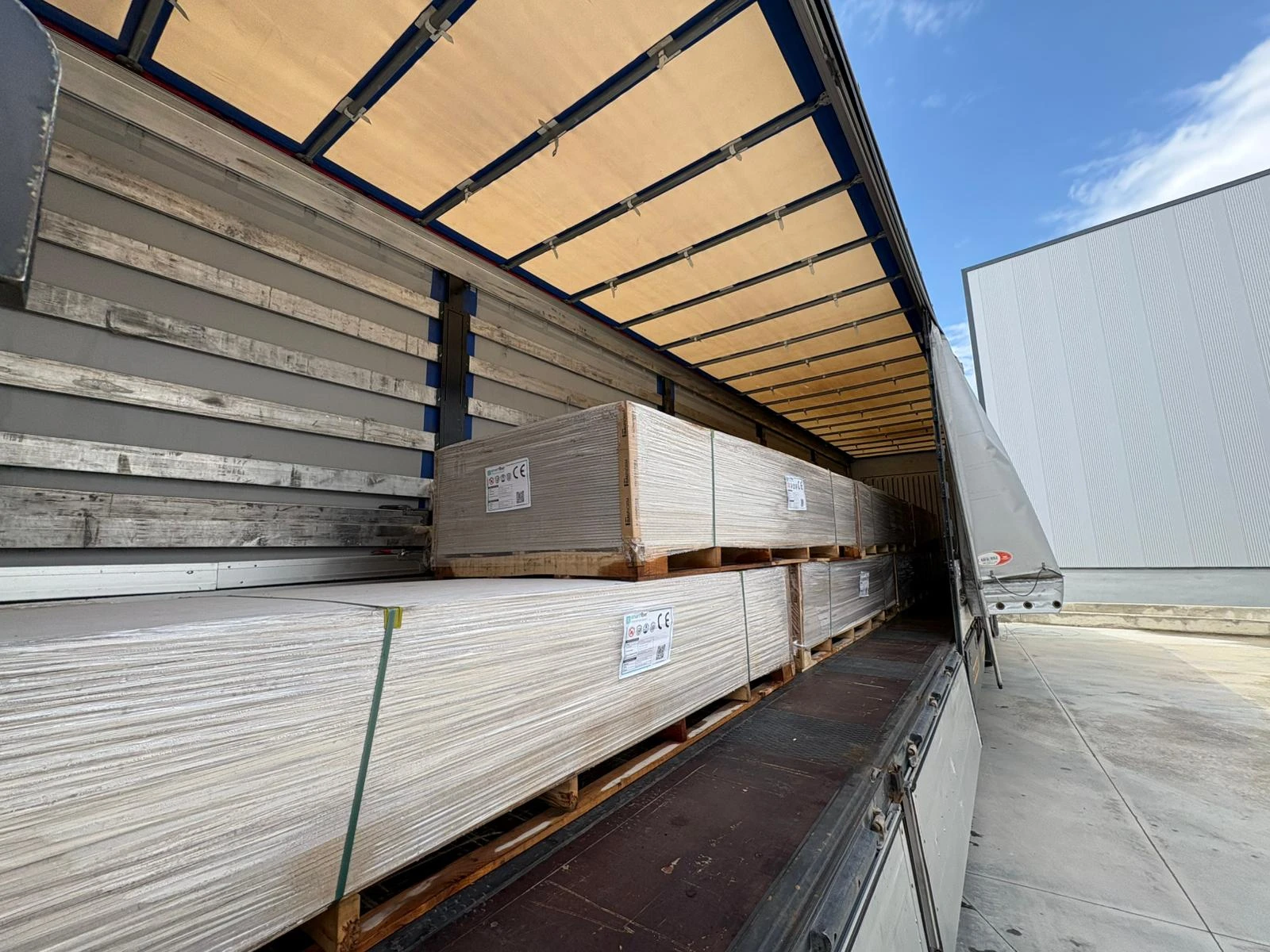 Packaged Smartfiber building boards loaded inside an export truck.