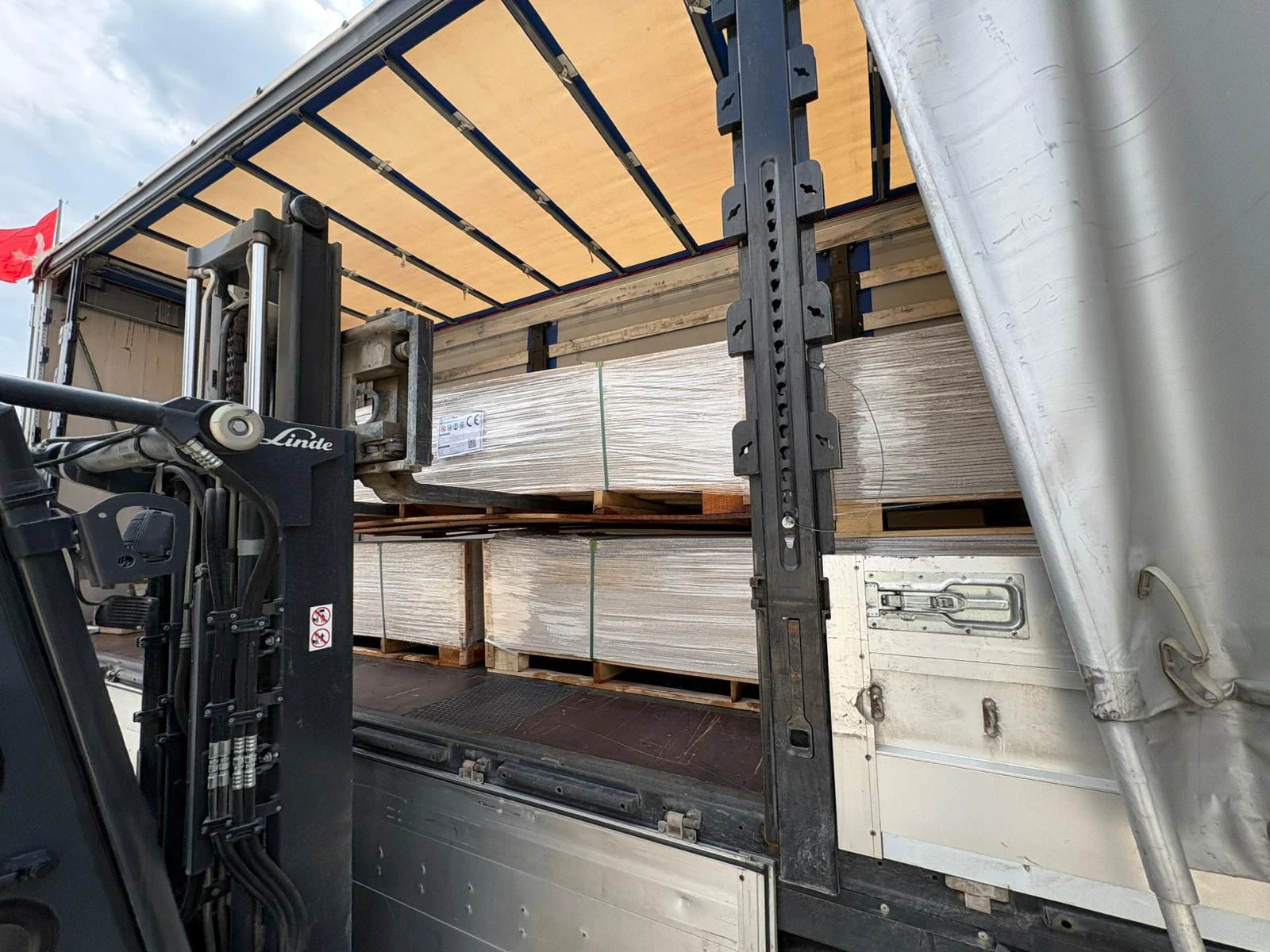 Forklift loading packaged Smartfiber building boards onto an export truck.