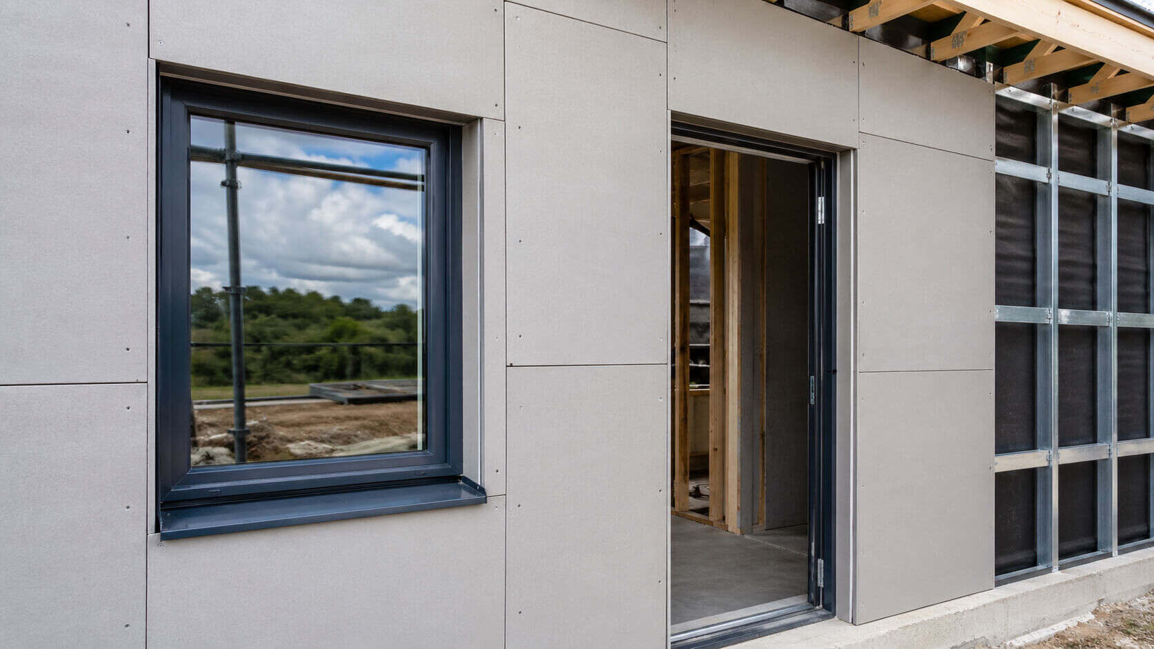 Fiber cement boards installed around window and door openings with clean joints, fixing points, and professional exterior wall detailing.